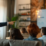 a real estate agent pointing at a graph showing detached homes market trends to a group of interested sellers.