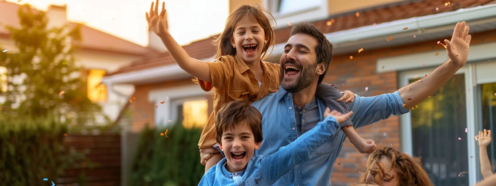 a family celebrating in front of their newly purchased detached home.